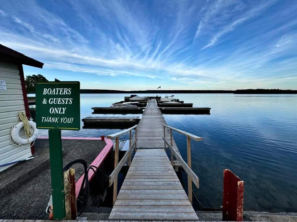 image of a main dock with several finger docks attached, The water is blue as well as the sky with a few whispy clouds.