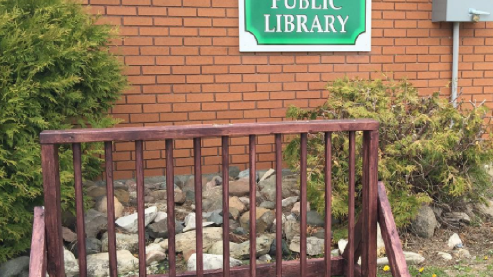 Bike rack and sign for Assiginack Public Library.