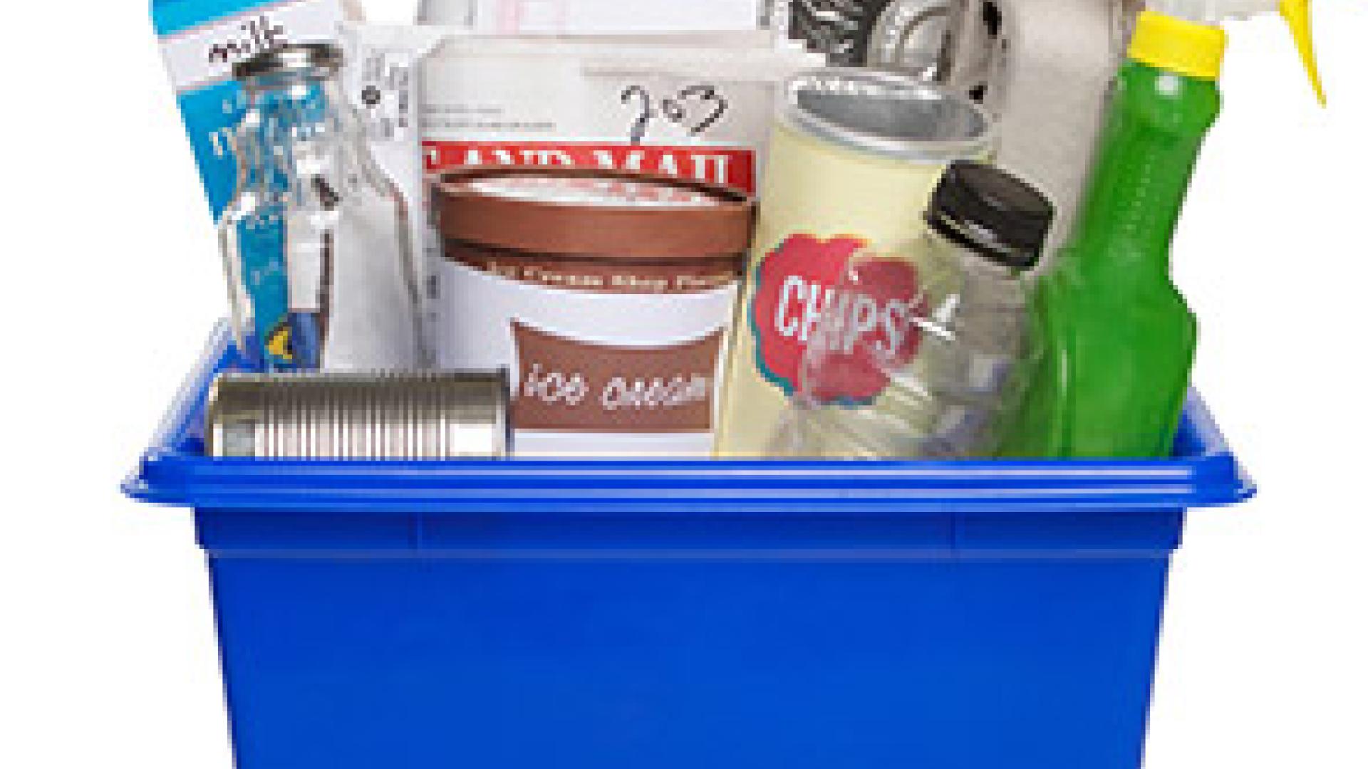 Recycling bin with assorted bottles, cans, and containers.